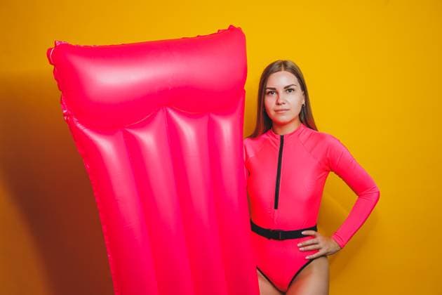 Young slender woman in a pink swimsuit on a yellow background. Girl with an inflatable mattress for swimming in the pool. Summer vacation., model released, , 48571398.jpg, woman, female, bikini, model, happy, girl, holiday, white, people, swimsuit, summer, person, sunglasses, adult, caucasian, beauty, cheerful, summertime, studio, leisure, beach, fashion, vacation, beautiful, water, yellow, pink, relax, travel, sexy, young, pool, posing, stylish, swim, body, float, red, blue, attractive, bed, inflatable, mattress, swimming, sunbathing, slim, lady, rubber, tropical, suntan RECORD DATE NOT STATED