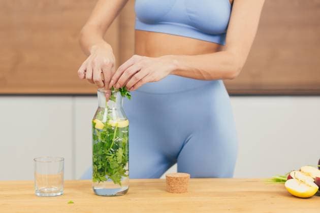 Close up photo, body part of young beautiful fitness woman preparing detox drink with fresh fruits, mint and lemon at home in the kitchen, model released, , 48620130.jpg, close-up, part of, body, portrait, women, lifestyles, preparing, one person, fitness, nutritionist, looking at camera, healthy lifestyle, lemonade, lemon - fruit, mint, juicy, people, healthy eating, adult, detox, one woman only, smoothie, adults only, domestic kitchen, juice - drink, only women, routine, young adult, drinking, vegetable, beautiful woman, color image, dieting, kitchen, morning, beauty, food and drink, ingredient, cooking, fruit, green color, apartment, carefree, enjoyment, exercising, females, slim, smiling, freshness, organic RECORD DATE NOT STATED
