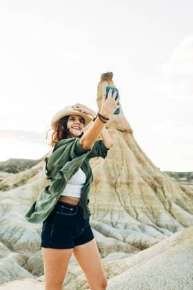 Smiling tourist taking selfie with Castildetierra in background model released, Symbolfoto, DAMF01234