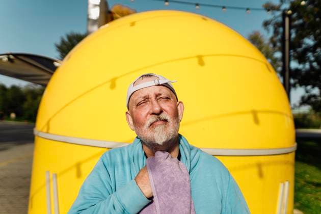 Senior man wearing cap and wiping off sweat at park model released, Symbolfoto, IEF00805