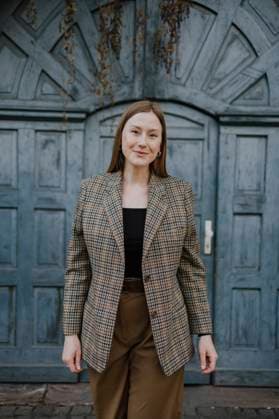 Smiling woman in blazer standing in front of door model released, Symbolfoto, MCHF00427