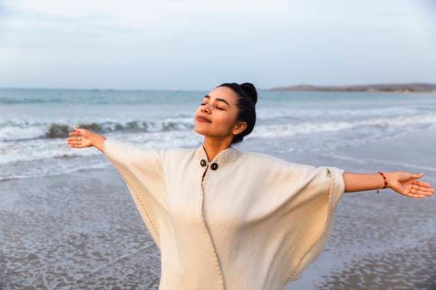Carefree woman with arms outstretched at beach model released, Symbolfoto, PCLF01648
