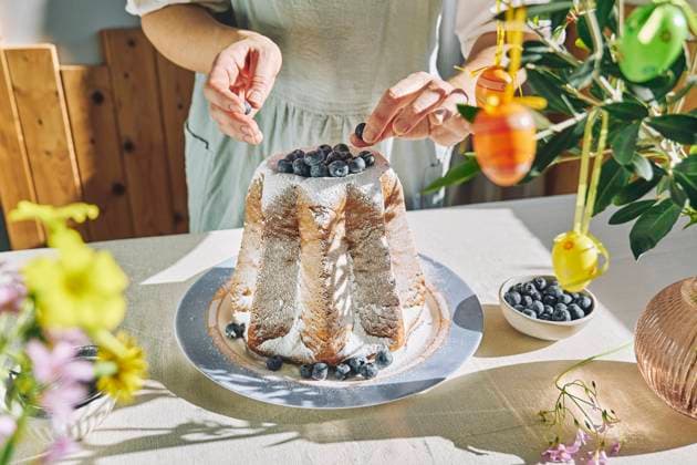 Woman decorating Pandoro bread with blueberries model released, Symbolfoto property released, CATF00575