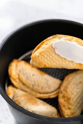 Frying sweet cherry empanadas in the air fryer. , 48778302.jpg, Air fryer, Baking, Cherry Empanadas, Cooking, Empanada, Frying, Pastry, Recipe, Sweet empanadas, airfryer, baked, bread, empada, frying pan, making, meat, pastel, preparing, stuffed, stuffing RECORD DATE NOT STATED