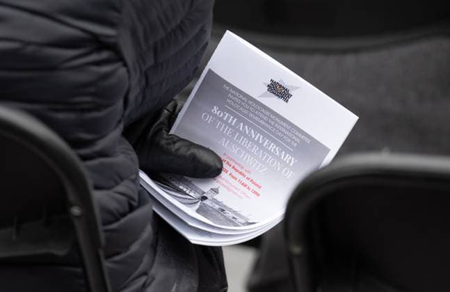 January 27, 2025, Ottawa, On, Canada: A person holds a program for a ceremony at the National Holocaust Monument, Monday, Jan 27, 2025 in Ottawa. Ottawa Canada  - ZUMAc35_ 20250127_zaf_c35_048 Copyright: xAdrianxWyldx