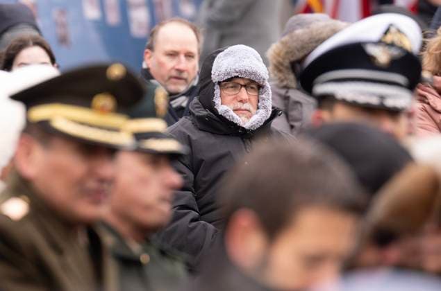 January 27, 2025, Ottawa, On, Canada: A man stays warm as he listens to speakers during a ceremony at the National Holocaust Monument, Monday, Jan 27, 2025 in Ottawa. Ottawa Canada  - ZUMAc35_ 20250127_zaf_c35_053 Copyright: xAdrianxWyldx