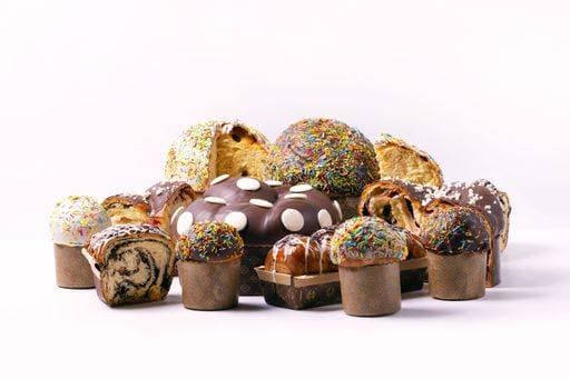 A variety of colorful and delicious panettone cakes with sprinkles and chocolate glaze on a white background. 28665541 RECORD DATE NOT STATED