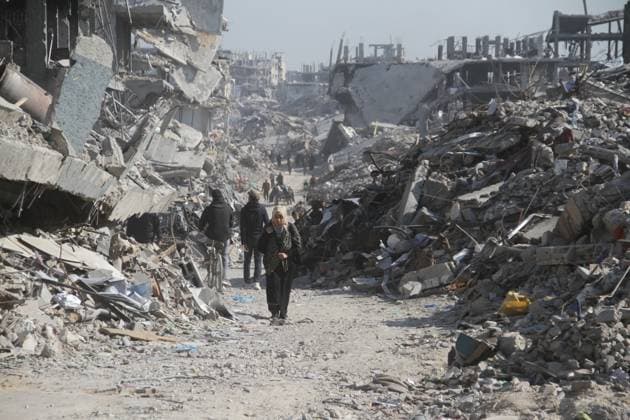 (250129) -- GAZA, Jan. 29, 2025 -- Palestinians are seen on a street with destroyed buildings in Jabalia refugee camp in the northern Gaza Strip, on Jan. 29, 2025. More than 500,000 displaced Palestinians have returned to northern Gaza in the past 72 hours, the Hamas-run media office said on Wednesday. (Photo by Xinhua) MIDEAST-GAZA-JABALIA REFUGEE CAMP-RETURN AbdulxRahmanxSalama 