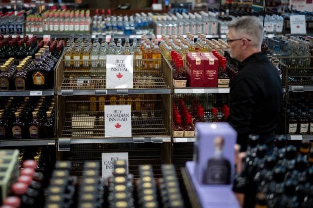 February 2, 2025, Vancouver, Bc, CANADA: A liquor store employee looks at a sign placed in the American whiskey section at a B.C. Liquor Store after top selling American made products have been removed from shelves in Vancouver, B.C., Sunday, Feb. 2, 2025. Vancouver CANADA  - ZUMAc35_ 20250202_zaf_c35_117 Copyright: xEthanxCairnsx