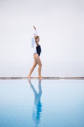An attractive young woman in a black swimsuit and white shirt stands near the pool with a panoramic view., model released, , 49143094.jpg, woman, beach, fashion, spa, water, person, girl, sport, fitness, erotic, vintage, summer, nature, face, sun, bikini, pool, swimming, view, swimsuit, female, young, people, swimwear, vacation, travel, luxury, relaxation, resort, leisure, one, indoors, sunbathing, rest, fashionable, sexy, recreation, villa, lifestyle, body, fun, hotel, slim, tropical, day, bali, pretty, style, outdoor, outdoors RECORD DATE NOT STATED