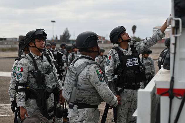 February 4, 2025, Tijuana, Baja California, Mexico: Members of the Mexican National Guard arrive at Military Air Base No. 12 near the Tijuana International Airport in Tijuana, Baja California, Mexico, on Tuesday, February 04, 2025. The arrival of MexicoÃ¢â‚¬â ¢s first 300 officers in the border city begins the 10,000 troop deployment President Claudia Sheinbaum had promised US President Donald Trump in exchange for delaying a 25-percent tariff on exported goods for a month with future negotiations to be determined. Tijuana Mexico - ZUMAm180 20250204_zip_m180_006 Copyright: xCarlosxA.xMorenox