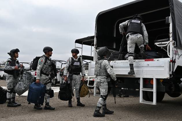 February 4, 2025, Tijuana, Baja California, Mexico: Members of the Mexican National Guard arrive at Military Air Base No. 12 near the Tijuana International Airport in Tijuana, Baja California, Mexico, on Tuesday, February 04, 2025. The arrival of MexicoÃ¢â‚¬â ¢s first 300 officers in the border city begins the 10,000 troop deployment President Claudia Sheinbaum had promised US President Donald Trump in exchange for delaying a 25-percent tariff on exported goods for a month with future negotiations to be determined. Tijuana Mexico - ZUMAm180 20250204_zip_m180_001 Copyright: xCarlosxA.xMorenox