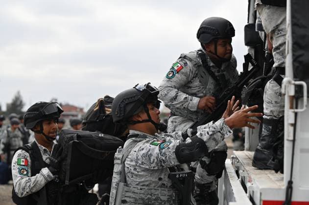 February 4, 2025, Tijuana, Baja California, Mexico: Members of the Mexican National Guard arrive at Military Air Base No. 12 near the Tijuana International Airport in Tijuana, Baja California, Mexico, on Tuesday, February 04, 2025. The arrival of MexicoÃ¢â‚¬â ¢s first 300 officers in the border city begins the 10,000 troop deployment President Claudia Sheinbaum had promised US President Donald Trump in exchange for delaying a 25-percent tariff on exported goods for a month with future negotiations to be determined. Tijuana Mexico - ZUMAm180 20250204_zip_m180_026 Copyright: xCarlosxA.xMorenox