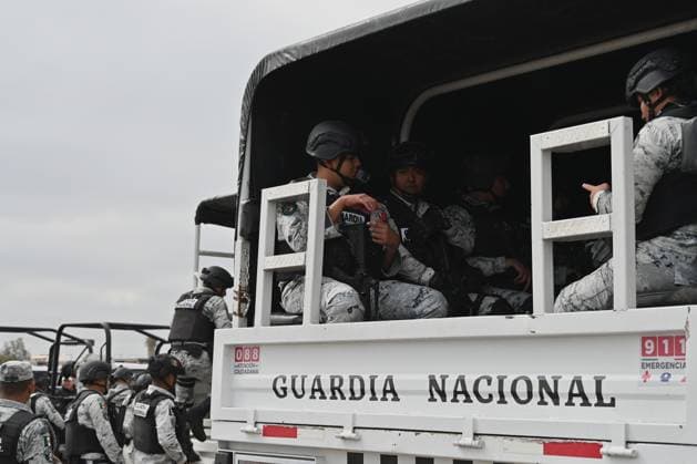 February 4, 2025, Tijuana, Baja California, Mexico: Members of the Mexican National Guard arrive at Military Air Base No. 12 near the Tijuana International Airport in Tijuana, Baja California, Mexico, on Tuesday, February 04, 2025. The arrival of MexicoÃ¢â‚¬â ¢s first 300 officers in the border city begins the 10,000 troop deployment President Claudia Sheinbaum had promised US President Donald Trump in exchange for delaying a 25-percent tariff on exported goods for a month with future negotiations to be determined. Tijuana Mexico - ZUMAm180 20250204_zip_m180_008 Copyright: xCarlosxA.xMorenox