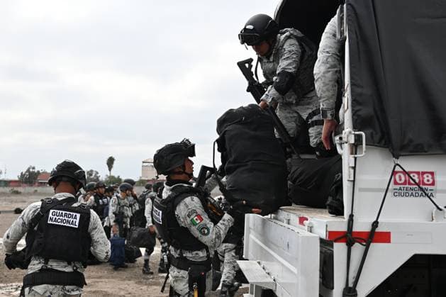 February 4, 2025, Tijuana, Baja California, Mexico: Members of the Mexican National Guard arrive at Military Air Base No. 12 near the Tijuana International Airport in Tijuana, Baja California, Mexico, on Tuesday, February 04, 2025. The arrival of MexicoÃ¢â‚¬â ¢s first 300 officers in the border city begins the 10,000 troop deployment President Claudia Sheinbaum had promised US President Donald Trump in exchange for delaying a 25-percent tariff on exported goods for a month with future negotiations to be determined. Tijuana Mexico - ZUMAm180 20250204_zip_m180_009 Copyright: xCarlosxA.xMorenox