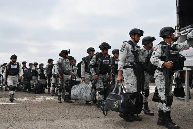 February 4, 2025, Tijuana, Baja California, Mexico: Members of the Mexican National Guard arrive at Military Air Base No. 12 near the Tijuana International Airport in Tijuana, Baja California, Mexico, on Tuesday, February 04, 2025. The arrival of MexicoÃ¢â‚¬â ¢s first 300 officers in the border city begins the 10,000 troop deployment President Claudia Sheinbaum had promised US President Donald Trump in exchange for delaying a 25-percent tariff on exported goods for a month with future negotiations to be determined. Tijuana Mexico - ZUMAm180 20250204_zip_m180_013 Copyright: xCarlosxA.xMorenox