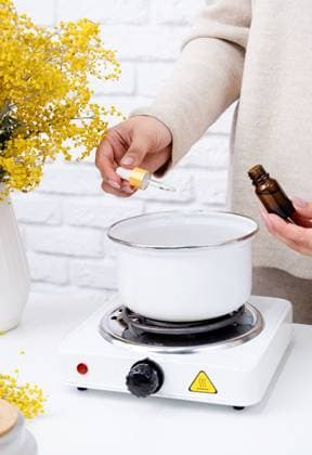 Creative hobby at home. Woman making decorative aroma candle at table, adding aroma oil , 50230606.jpg, candle, wax, home, person, making, woman, female, background, aroma, craft, handmade, creative, closeup, workshop, diy, hobby, crafting, homemade, wick, table, glass, white, aromatic, work, process, scent, made, candles, stove, cozy, paraffin, essential, art, style, decorative, produce, adult, melted, interior, hand, decoration, equipment, natural, floral, preparation, scented, ingredients, hands, decor, simple RECORD DATE NOT STATED