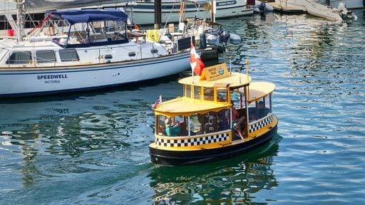 RECORD DATE NOT STATED A bright yellow harbor ferry with people on it traveling on the ocean water at Victoria, BC 23826479