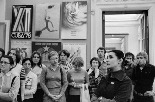 Moscow, USSR. Participant in the exhibition of works of young artists, poster artist member of the Union of Artists of the USSR Olga Volkova (R front) and visitors of the exhibition workers and employees of the Likhachev Moscow Automobile Plant observe the exhibition in a hall of the Academy of Arts of the Soviet Union on Kropotkinskaya Street. Lyudmila Pakhomova TASS  16954622