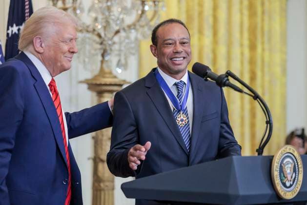 Golfer Tiger Woods speaks as US President Donald J. Trump watches during a reception honoring Black History Month in the East Room of the White House in Washington, DC, on February 20, 2025.  WAX20250220808 SHAWNxTHEW