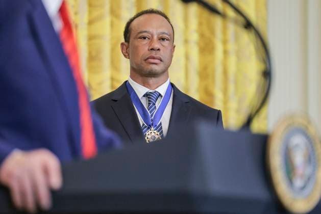 Golfer Tiger Woods listens to US President Donald J. Trump deliver remarks during a reception honoring Black History Month in the East Room of the White House in Washington, DC, on February 20, 2025.  WAX20250220869 SHAWNxTHEW