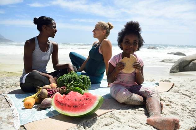 Creative Highlights Symbolfotos Mother with daughter and friend having a picnic on the beach model released, Symbolfoto, ECPF00425