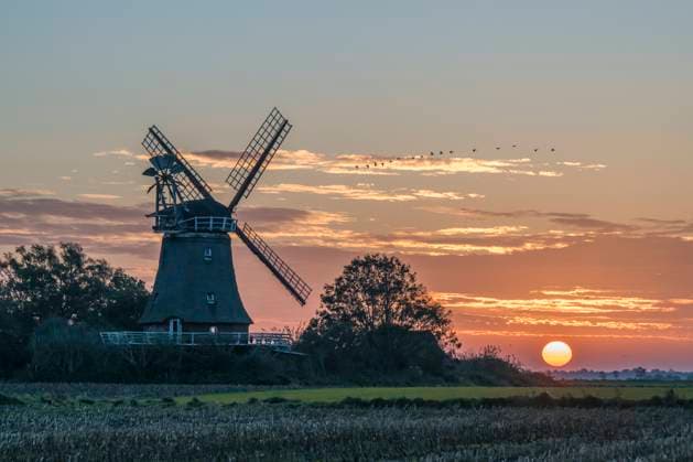 Windmill at sunrise in Oldsum, Föhr, Schleswig-Holstein, Germany, KEBF03084