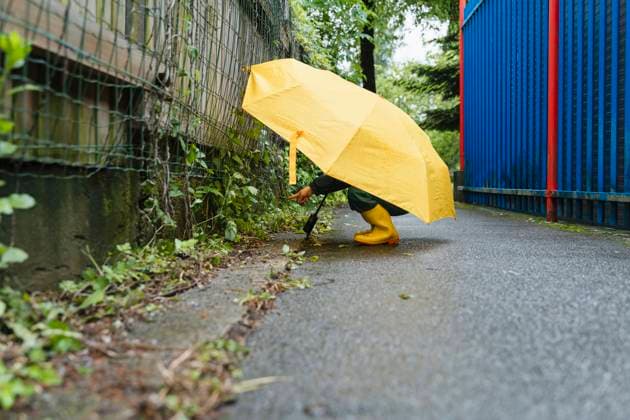 Playful child with yellow umbrella and boots exploring outdoors in the rain model released, Symbolfoto, NDEF02199