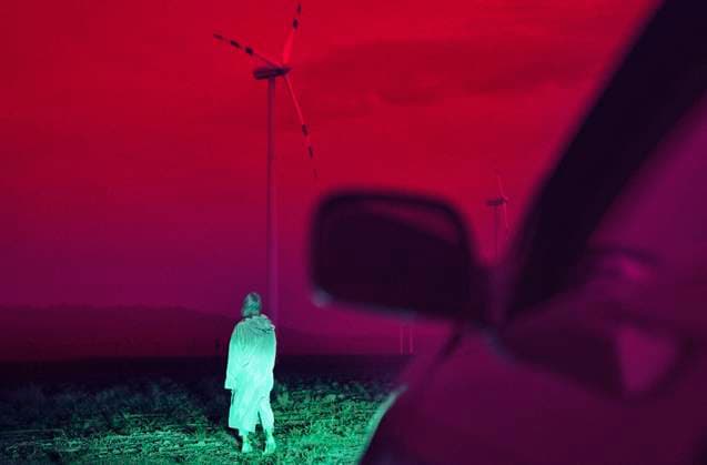 Creative Highlights Symbolfotos Surreal landscape with a woman walking near wind turbines at night model released, Symbolfoto, AZF00635