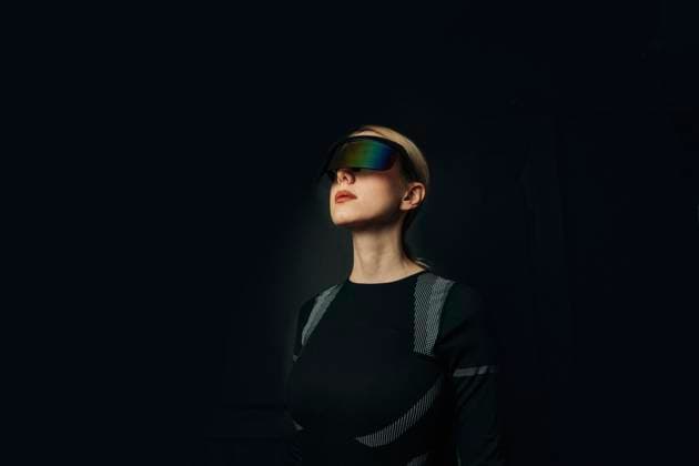 Creative Highlights Symbolfotos Person wearing VR glasses in a dark setting with a futuristic theme model released, Symbolfoto, VSNF02931