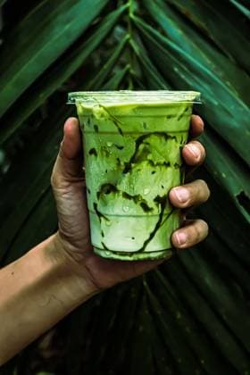 iced Green matcha tea mixed with ice cube and milk in latte glass with green nature background , 51124234.jpg, hand, holding, latte, matcha, cup, iced, japanese, freshness, tea, cool, refreshing, healthy, asian, refreshment, green, table, beverage, summer, cold, tasty, cafe, nutrition, drink, cream, milk, natural, glass, smoothie, white, plant, leaf, nature, agriculture, isolated, environment, life, care, grow, gardening, concept, seedling, human, growing, ecology, leaves, garden, protection RECORD DATE NOT STATED