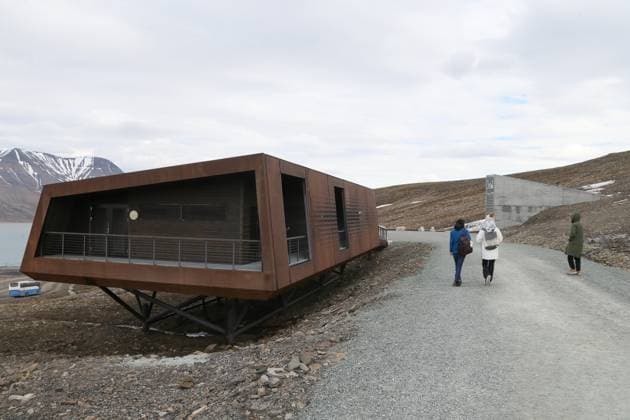(250226) -- LONGYEARBYEN (NORWAY), Feb. 26, 2025 -- File photo taken on June 19, 2024 shows people walking toward the entrance of the Svalbard Global Seed Vault in Longyearbyen, Norway. A total of 14,000 seed samples from 21 gene banks are being deposited this week in the Svalbard Global Seed Vault, the Norwegian government announced on Feb. 26, 2025. ) FILE-NORWAY-LONGYEARBYEN-SVALBARD GLOBAL SEED VAULT-NEW SEEDS ZhangxYuliang 