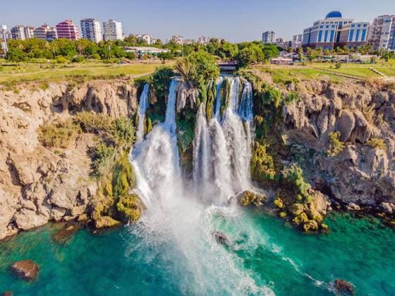 Lower Duden Falls drop off a rocky cliff falling from about 40 m into the Mediterranean Sea in amazing water clouds. Tourism and travel destination photo in Antalya, Turkey. Turkiye , 51468238.jpg, waterfall, duden, turkey, Turkiye, antalya, water, stone, nature, sea, tourism, river, rock, fall, green, travel, landscape, park, cliff, city, outdoors, wave, summer, resort, high, tree, beach, mediterranean, landmark, background, holiday, low, outdoor, lower, district, flowing, vacations, house, sun, falling water, tourist, canyon, foam, touristic, cascade, boat, building, stream, seaside, view, coastline RECORD DATE NOT STATED