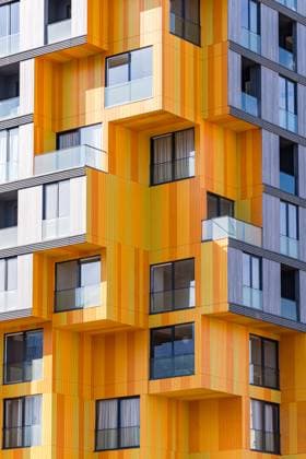 Creative Highlights World A cutting-edge design in suburban modern architecture, highlighting a dynamic combination of materials such as glass, concrete, and metal. Vibrant orange panels interspersed with grey provide a fresh take on urban building exteriors. Model Released AnnaBogush_ID26966_778343_012 Copyright: xAnnaxBogushx RECORD DATE NOT STATED