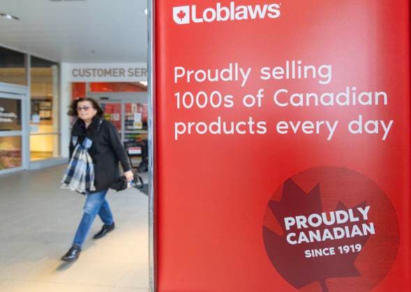 (250304) -- TORONTO, March 4, 2025 -- A woman walks past a poster with the words PROUDLY CANADIAN at a supermarket in Toronto, Ontario, Canada, on March 4, 2025. The Canadian federal government on Tuesday announced a detailed tariff package after Prime Minister Justin Trudeau vowed that Canada will not back down from a fight against the trade war initiated by U.S. President Donald Trump. (Photo by Xinhua) CANADA-ONTARIO-U.S.-COUNTER TARIFF PACKAGE ZouxZheng 