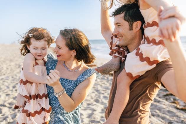 Creative Highlights Symbolfotos Family of Four at the beach smiling in dresses Boca Raton, Florida, United States CR_NYHM250226A-1668038-01 ,model released, Symbolfoto