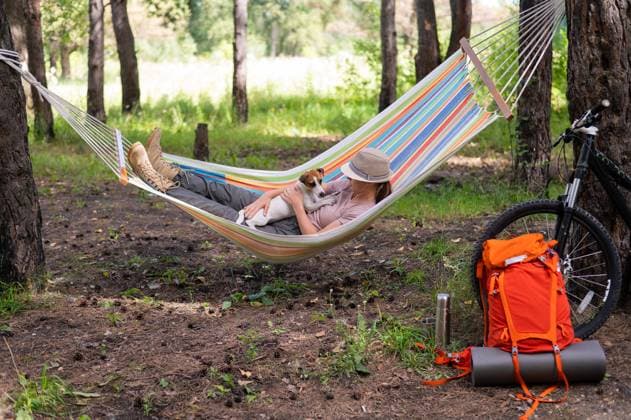 Caucasian woman lies in a hammock with Jack Russell Terrier dog in a pine forest., model released, , 52185716.jpg, woman, resting, hammock, dog, nature, vacation, trip, travel, enjoying, activities, camp, campfire, forest, hike, journey, leisure, outdoors, summer, relaxing, laying, carefree, exploration, lifestyle, tree, pine, female, wood, lying, log, outside, recreation, adventure, backpack, campground, park, picnic, rural, girl, grass, atmosphere, hipster, holiday, mood, campsite, laziness, joy, jack russell terrier, caucasian, friend, love RECORD DATE NOT STATED