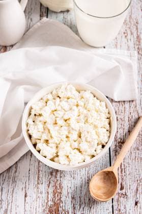 Farm homemade cottage cheese in a bowl on the table vertical view Farm homemade cottage cheese in a bowl on the table vertical view Copyright: xZoonar.com ElenaxRuix 22966609