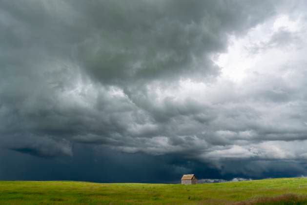 Lonely abandoned barn facing incoming supercell storm in the great plains Ominous supercell storm clouds gathering over a lonely abandoned barn in the vast great plains Copyright: xZoonar.com mark.duffyx 23014342