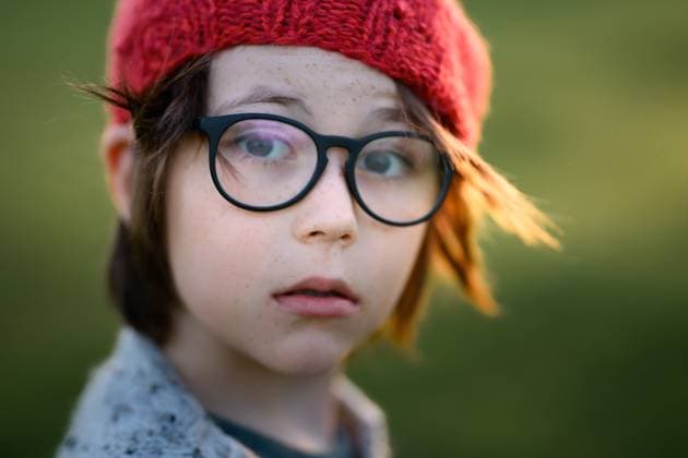 Creative Highlights Symbolfotos MR_ID26944_20119_MayaBosquetCarli.jpg, MR_ID26944_20120_LeoBosquetCarli.jpg A young boy wearing a red knitted hat and glasses gazes introspectively, embodying the essence of an autumn sunset. His expressive eyes and freckles are highlighted by the soft, natural light. Model Released MagdalenaCarli_ID26944_777552_018 Copyright: xMagdalenaxCarlix