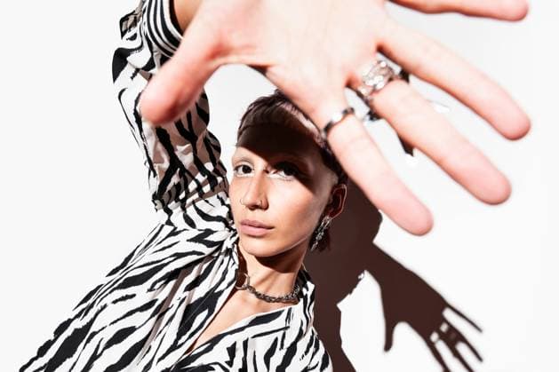 Creative Highlights Symbolfotos A dynamic shot of a fashion model in a zebra animal print outfit, with dramatic shadows and bold accessories, captured using flash photography in a studio setting. Model Released ManuelRuiz_ID27375_785316_023 Copyright: xManuelxRuizx