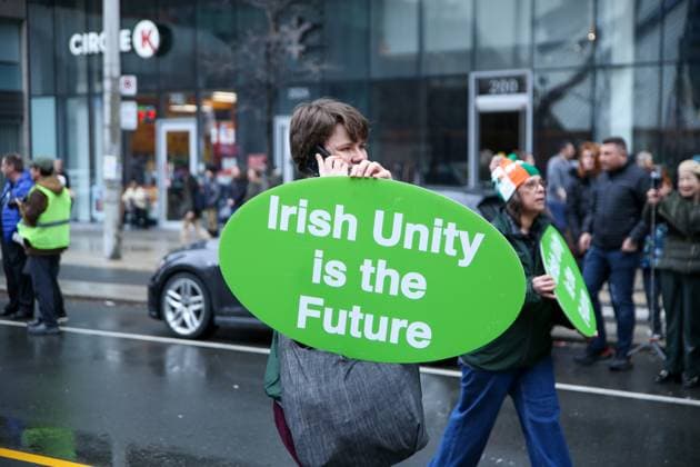 2025 Toronto St. Patrick s Day Parade A parade participant carries a sign that says Irish Unity is the Future while on the phone during the 2025 Toronto St. Patrick s Day Parade in Toronto, Ontario, Canada, on March 16, 2025. Toronto Ontario Canada  Copyright: xIndrawanxKumalax originalFilename: kumala-2025toro250316_npEVZ.jpg