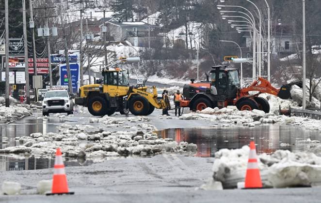 March 17, 2025, Beauceville, Pq, Canada: A payloader carries a block of ice left on the highway 183 in Beauceville, Que., Monday, March 17, 2025. The Chaudiere river flooded the city after an ice blockage overnight. Beauceville Canada  - ZUMAc35_ 20250317_zaf_c35_087 Copyright: xJacquesxBoissinotx