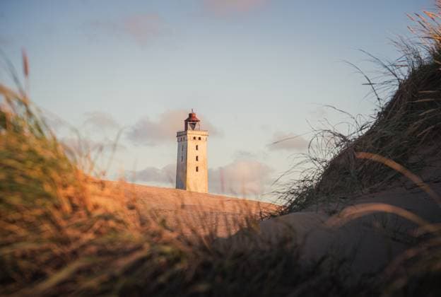 Rubjerg Knude Lighthouse in sand dunes in northern Denmark at sunset Løkken, Denmark R_PJJZ250318B-1682777-01