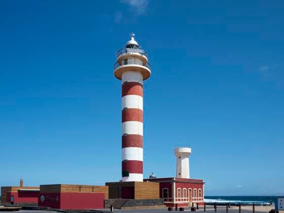 Red and white striped lighthouse with outbuildings against a clear blue sky. Fuerteventura, Spain Fuerteventura Spain bola07730 Copyright: xConnectxImagesx
