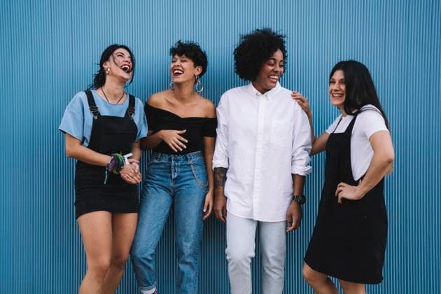 Creative Highlights Symbolfotos Laughing women in front of a blue wall model released, Symbolfoto, DAMF00209