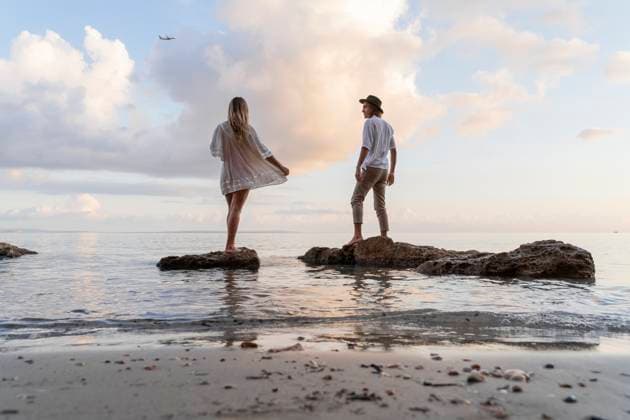 Creative Highlights Symbolfotos Back view of young couple standing on rocks in front of the sea, Ibiza, Balearic Islands, Spain model released, Symbolfoto, AFVF04280