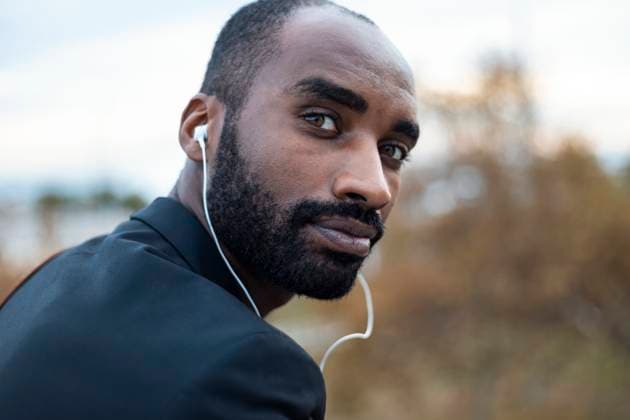 Creative Highlights Symbolfotos Portrait of bearded young businessman with earphones outdoors model released, Symbolfoto, Barcelona Barcelona Spain JSRF00717