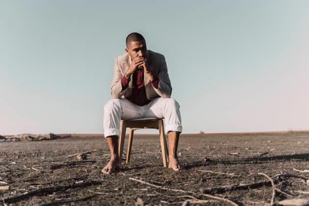 Creative Highlights Symbolfotos Young man sitting on chair in barren land model released, Symbolfoto, ERRF02446