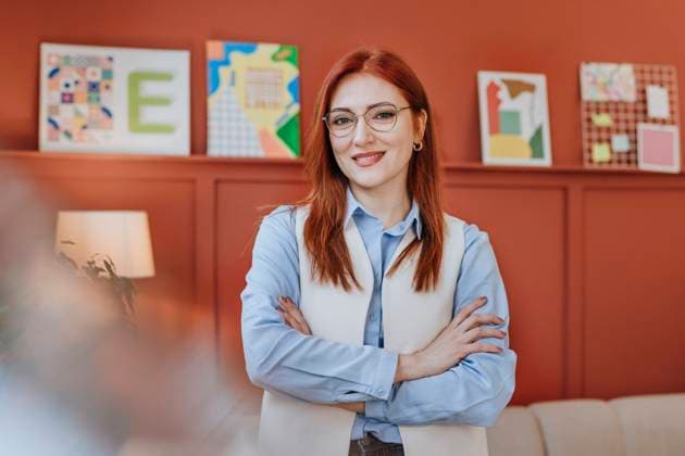 Creative Highlights Symbolfotos Business woman with red hair and glasses smiling confidently in a design studio office model released, Symbolfoto property released, YTF03540